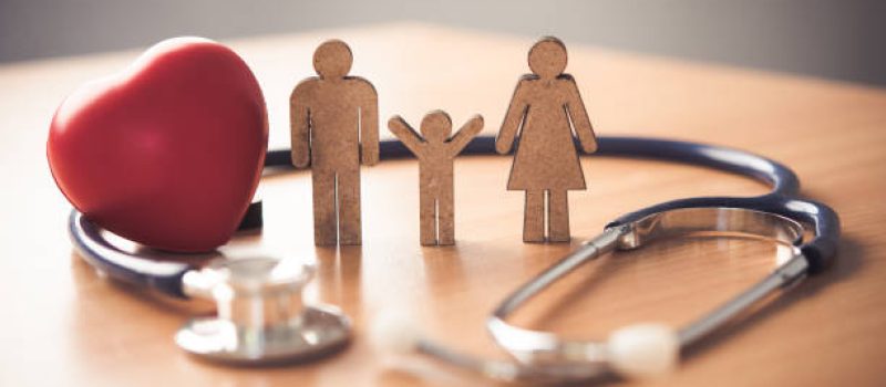 Medical Insurance Concept With Family  And Stethoscope On Wooden Desk